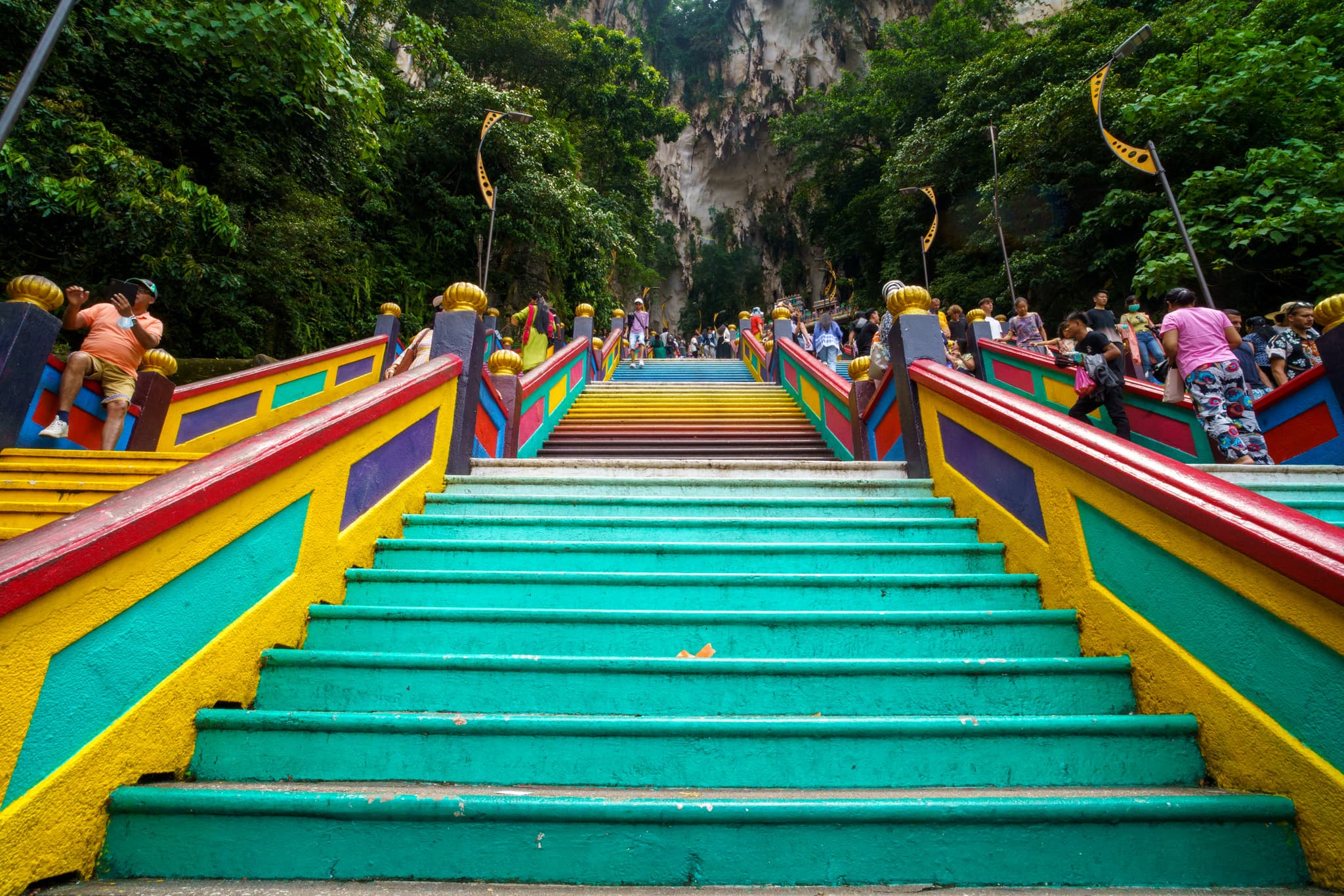 Colourful Batu Caves stairs beneath limestone cliffs, photographed by Pedro J Pacheco in August 2023