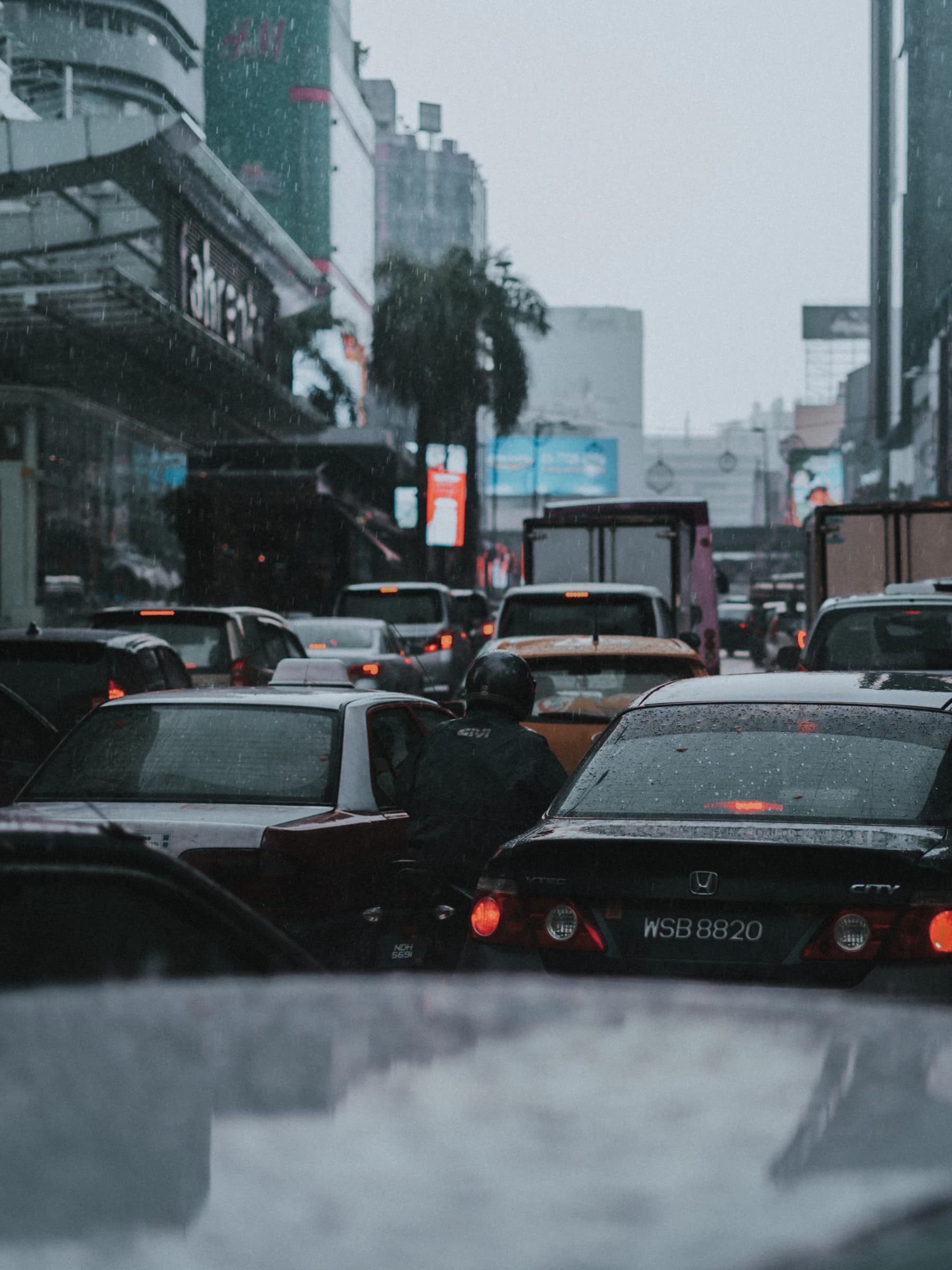 A car travelling through Kuala Lumpur in the rain