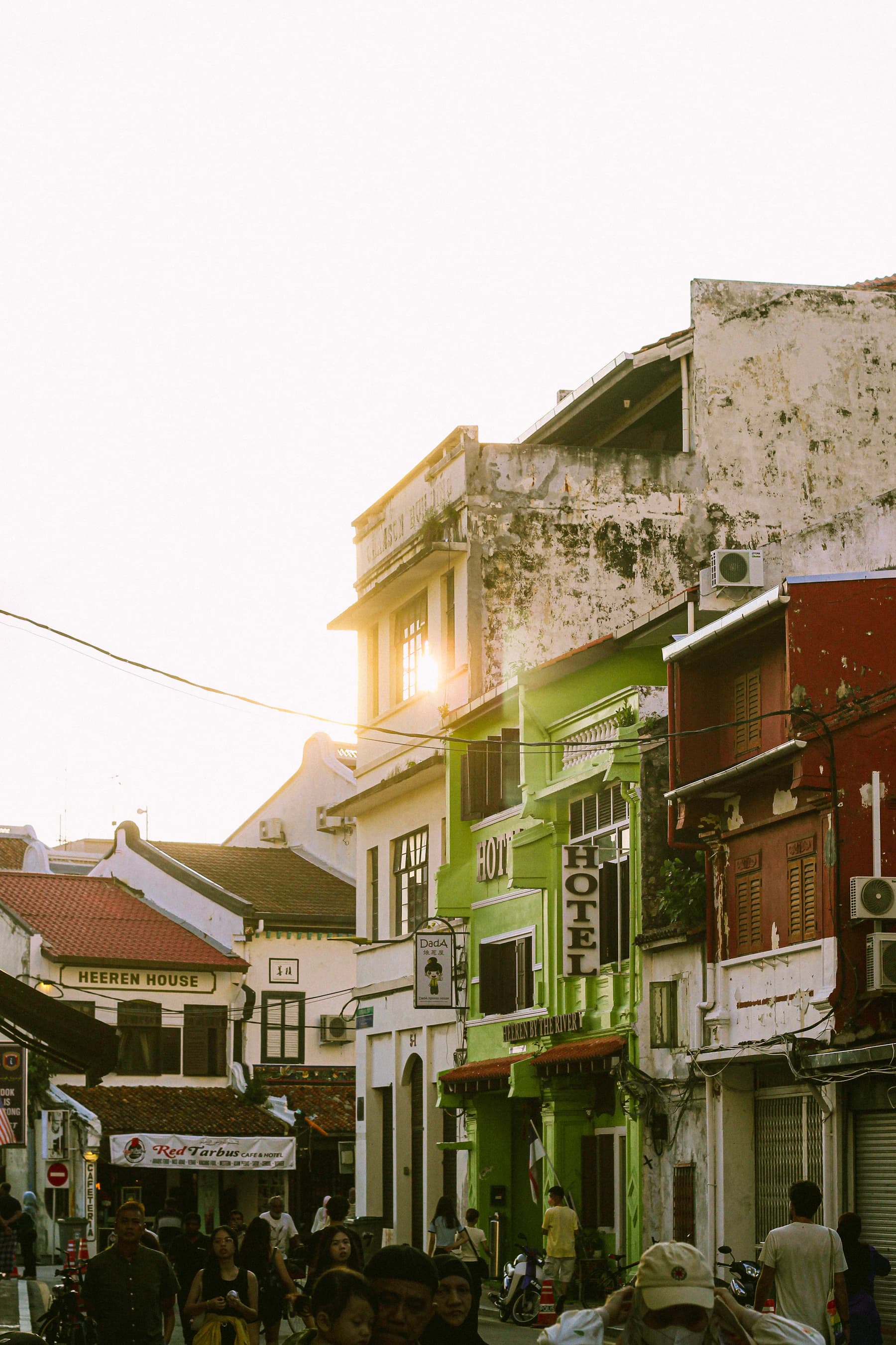 Visitors walking along a lively heritage street in Melaka