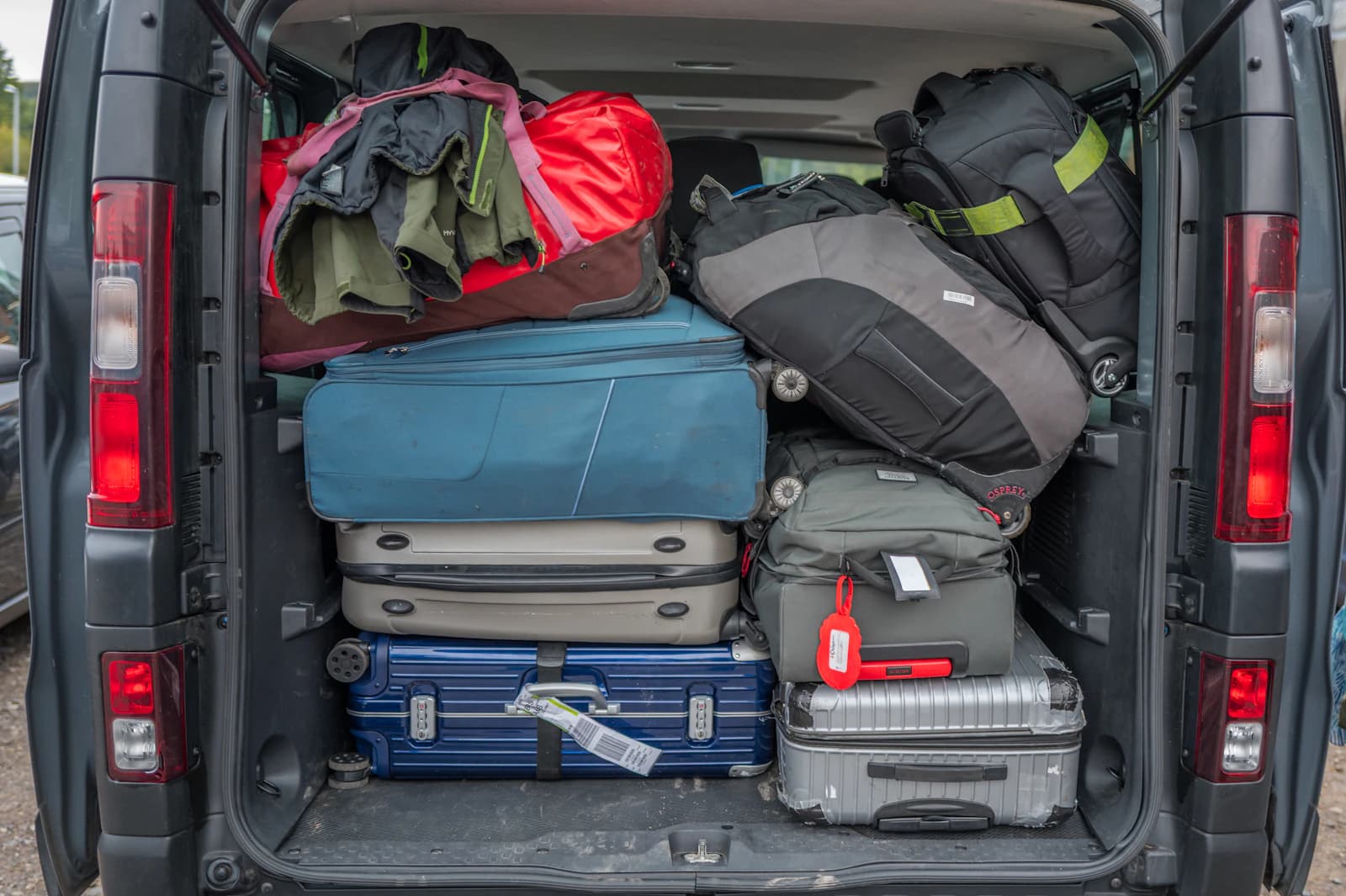 Passenger van boot packed with suitcases and travel bags